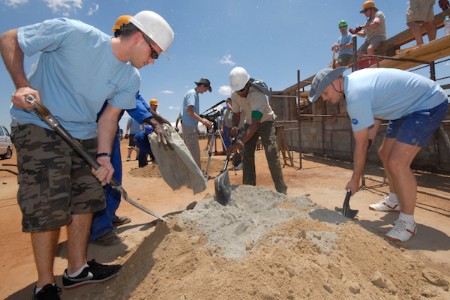 corporate volunteer group building social housing together