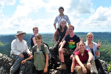 Social volunteer group posing on a rocky outlook