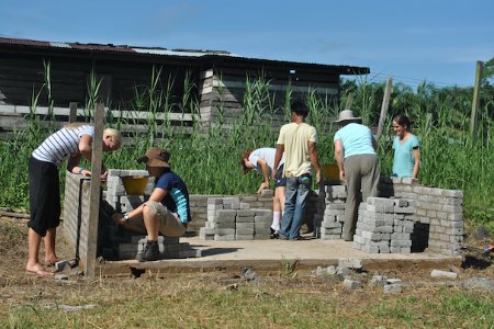 School and college volunteer group building a structure