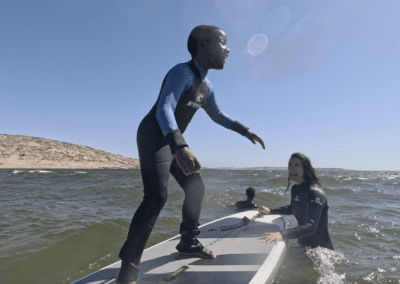 woman teaching child to surf in Namibia