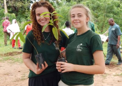 Two volunteers holding plants.