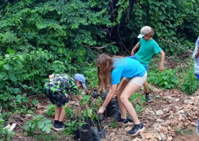 Three volunteers digging.