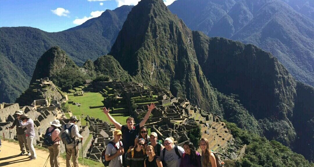 Machu Picchu with group of people in front
